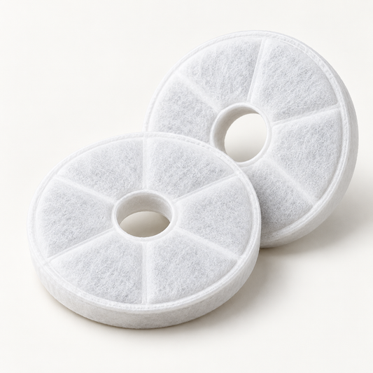 Two white circular fountain filter pads photographed together on an off-white studio background.