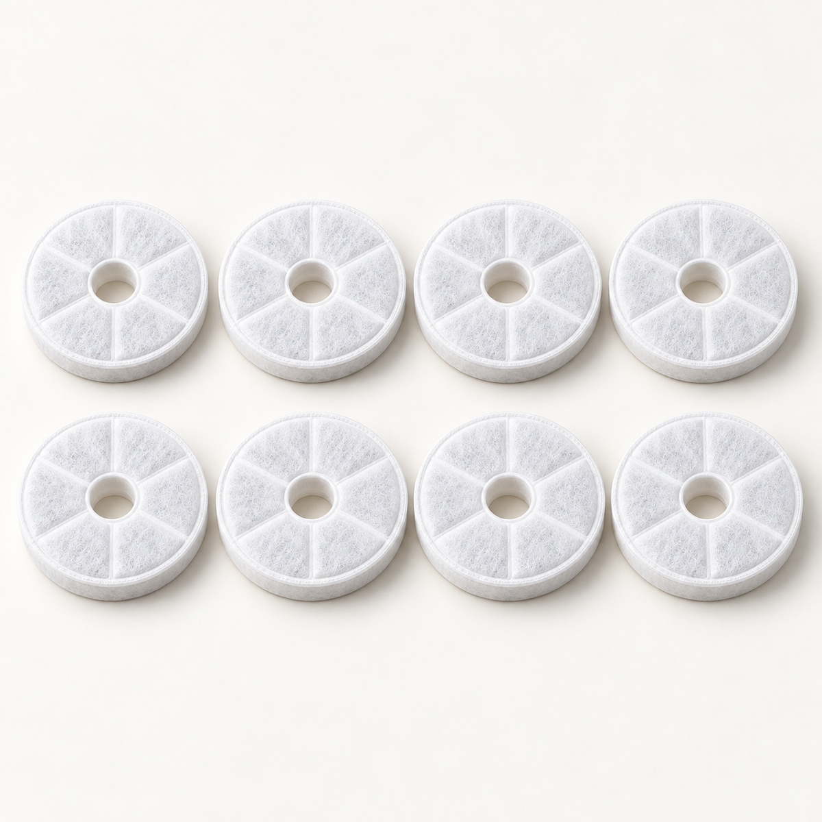 Eight white replacement fountain filters arranged in two rows of four on an off-white studio background.