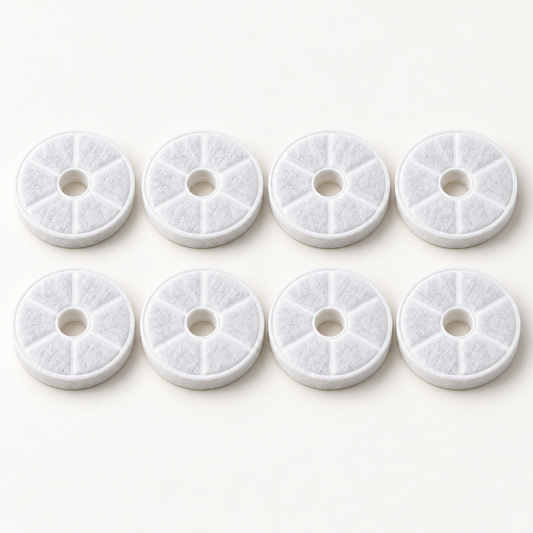 Eight white replacement fountain filters arranged in two rows of four on an off-white studio background.