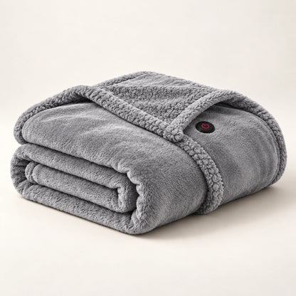 Gray heated wearable blanket folded on an ivory studio background